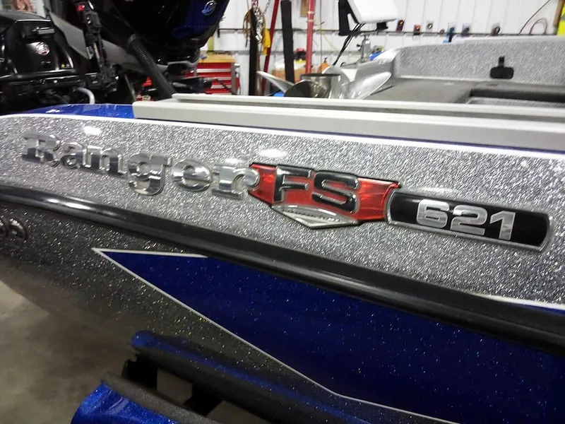 Slide: The Image of 2018 Ranger 621FS Fisherman boat with metallic finish in a workshop setting. - 2
