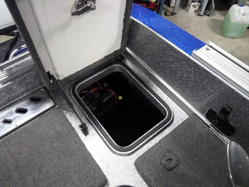 Slide: The Image of 2018 Ranger 621FS Fisherman boat storage compartment with open hatch, showing interior details. - 30