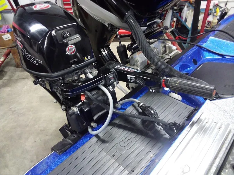 Slide: The Image of 2018 Ranger 621FS Fisherman boat motor and steering mechanism in a garage setting. - 4