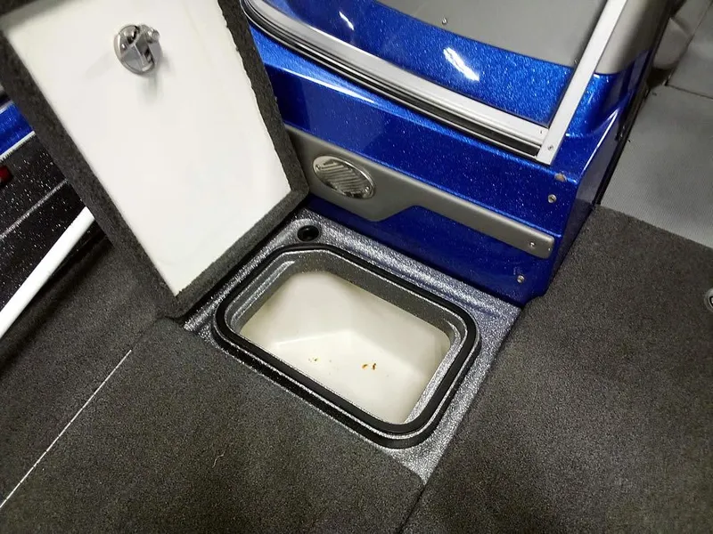 Slide: The Image of 2018 Ranger 621FS Fisherman boat storage compartment with open hatch, blue exterior, and carpeted interior. - 8