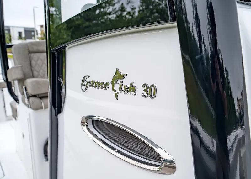 Slide: The Image of 2025 Sea Hunt Gamefish 30 CB boat, close-up of logo and seating area. - 22