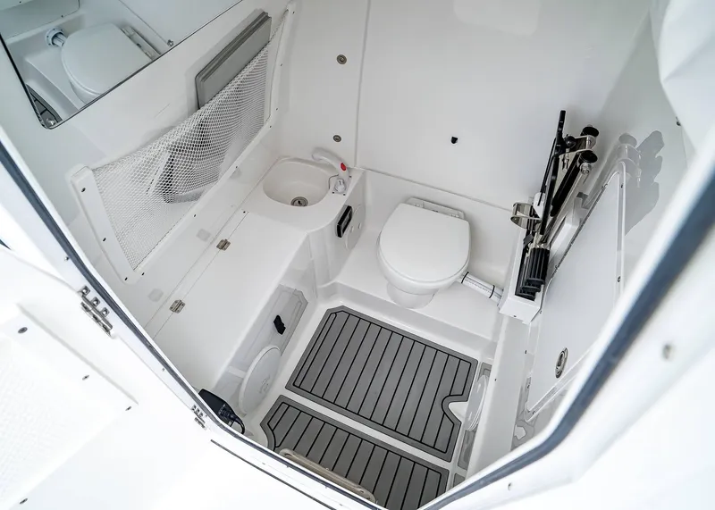 Slide: The Image of 2025 Sea Hunt Gamefish 30 CB boat interior with toilet and sink, featuring modern design. - 23