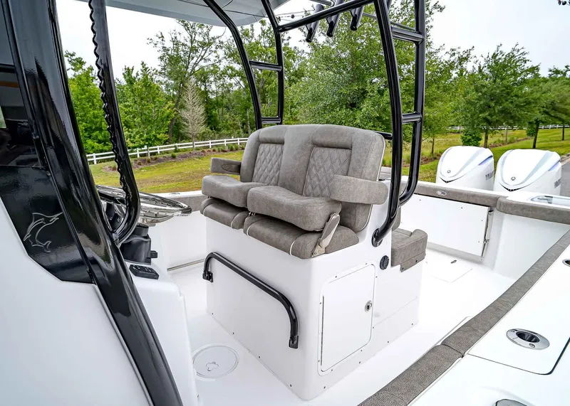 Slide: The Image of 2025 Sea Hunt Gamefish 30 CB boat interior with cushioned seating and dual outboard motors. - 25