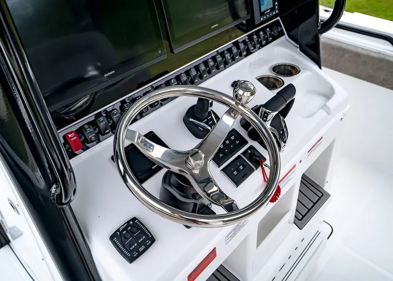 Slide: The Image of 2025 Sea Hunt Gamefish 30 CB helm with steering wheel and control panel. - 26
