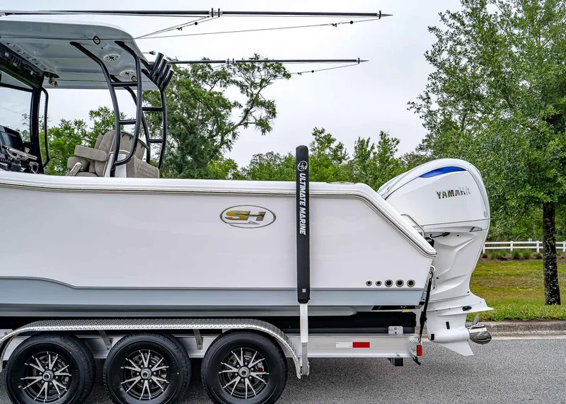 Slide: The Image of 2025 Sea Hunt Gamefish 30 CB boat on trailer with Yamaha engine, parked outdoors. - 3