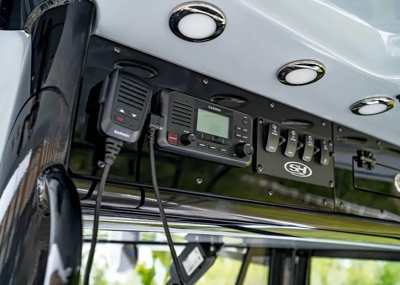 Slide: The Image of 2025 Sea Hunt Gamefish 30 CB dashboard with Garmin radio and control switches. - 31