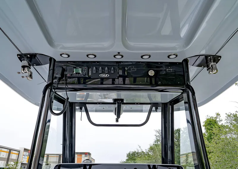 Slide: The Image of 2025 Sea Hunt Gamefish 30 CB console with electronics and controls, viewed from below. - 32