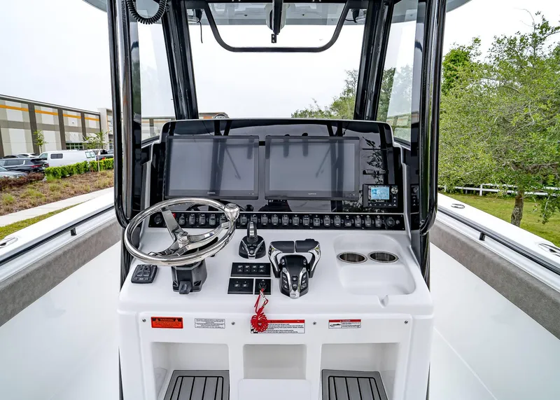 Slide: The Image of 2025 Sea Hunt Gamefish 30 CB helm with advanced navigation and control systems. - 33