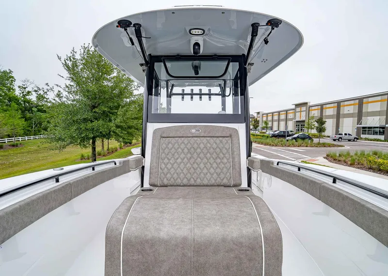 Slide: The Image of 2025 Sea Hunt Gamefish 30 CB boat interior with cushioned seating and modern design. - 35