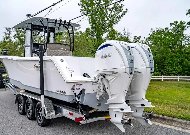 Slide: The Image of 2025 Sea Hunt Gamefish 30 CB boat with dual Yamaha engines on a trailer. - 4