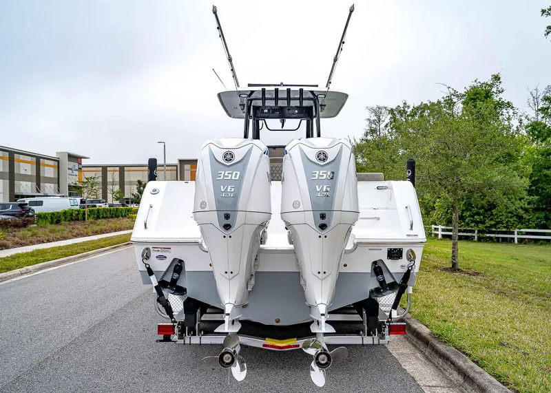 Slide: The Image of 2025 Sea Hunt Gamefish 30 CB with dual 350 V6 engines, parked on a street. - 5