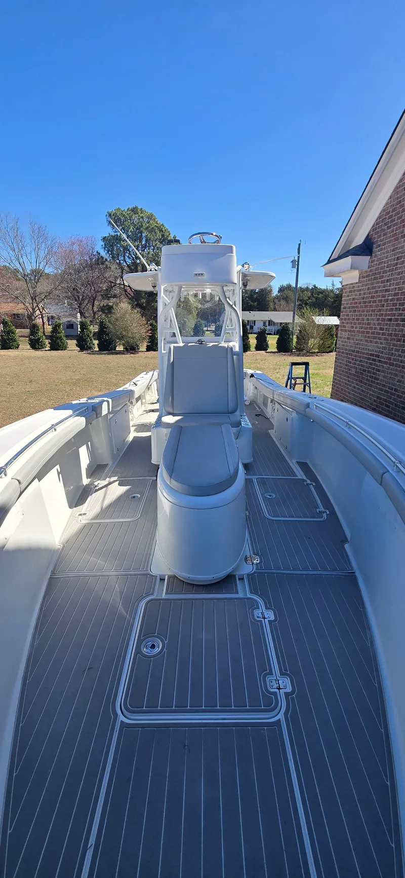 Slide: The Image of 2017 Yellowfin 36 boat with sleek deck design under clear blue sky. - 17