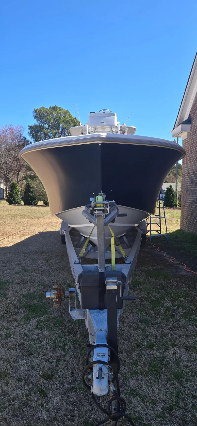 Slide: The Image of 2017 Yellowfin 36 boat on trailer, parked outdoors under clear blue sky. - 18