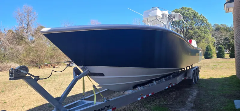 Slide: The Image of 2017 Yellowfin 36 boat on trailer, parked outdoors on a sunny day. - 2