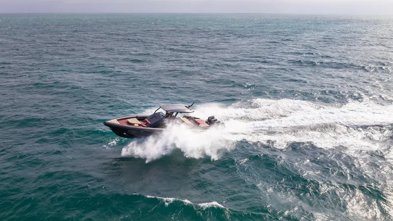 Slide: The Image of Skipper-BSK 42 boat cruising on open sea, 2023 model, creating waves. - 11