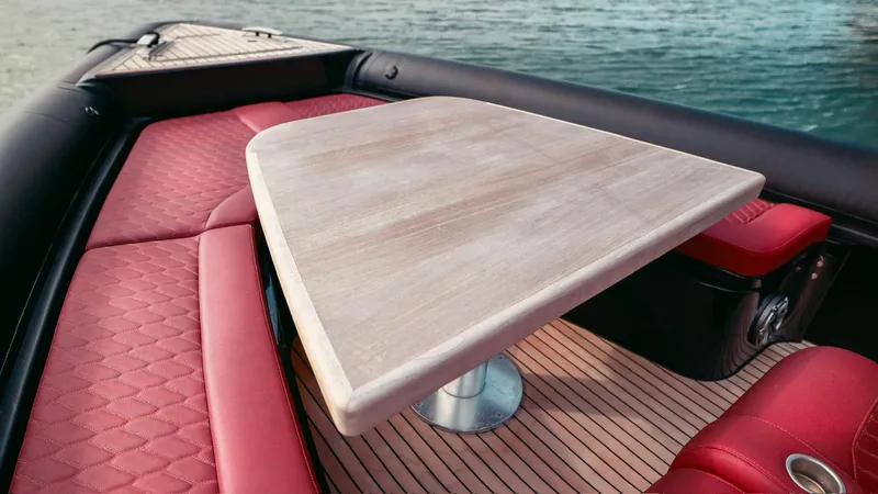 Slide: The Image of 2023 Skipper-BSK 42 boat interior with red seating and wooden table. - 17