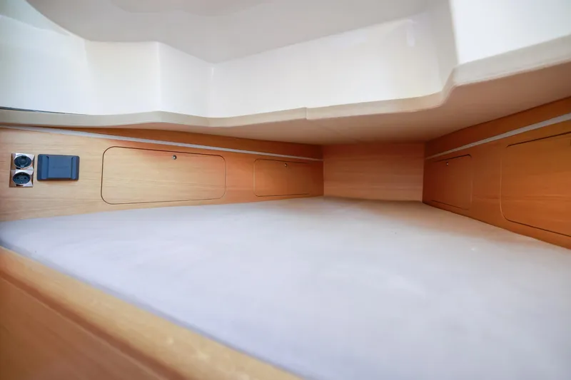 Slide: The Image of Interior cabin of 2023 Skipper-BSK 42 boat, featuring wooden storage compartments. - 19