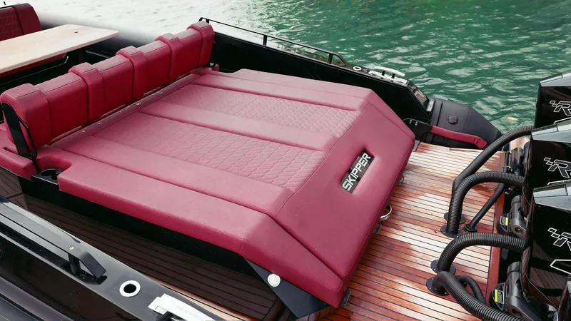 Slide: The Image of Luxury Skipper-BSK 42 boat with red seating, 2023 model, docked on water. - 34