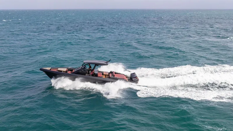 Slide: The Image of 2023 Skipper-BSK 42 boat cruising on open sea, creating white waves. - 35