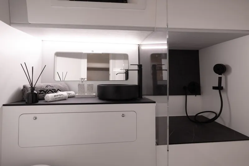 Slide: The Image of Modern bathroom interior in Introductory ZYARA 44, 2025 model, featuring sleek black and white design. - 19