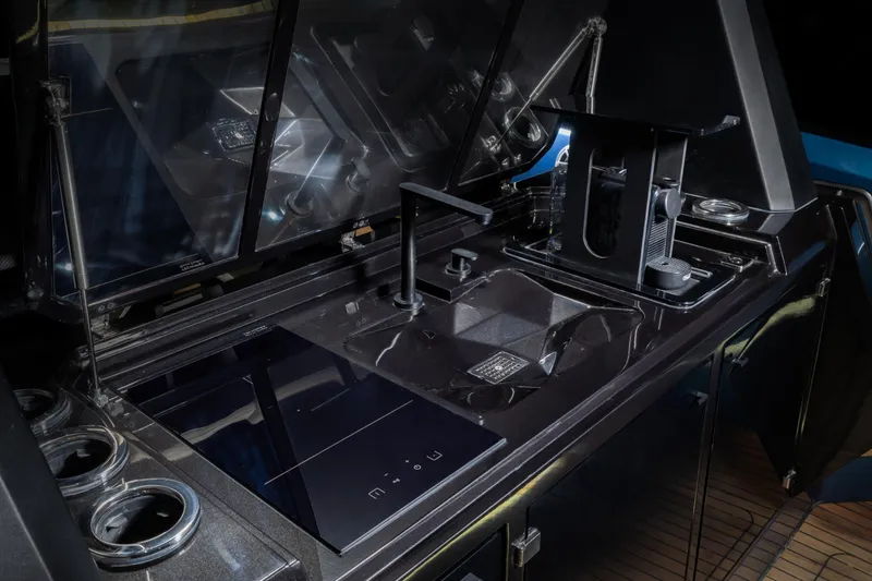 Slide: The Image of Modern yacht kitchen with sleek black countertops, integrated sink, and appliances on the Introductory ZYARA 44. - 22