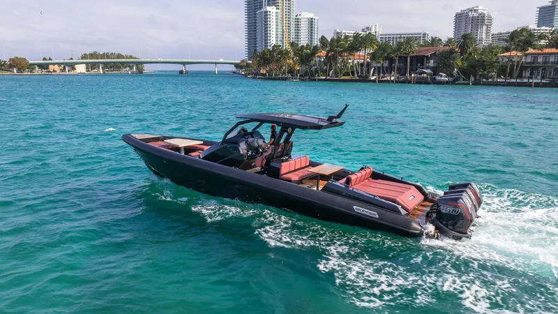 Slide: The Image of 2023 Skipper-BSK 42 boat cruising on turquoise water near city skyline. - 0