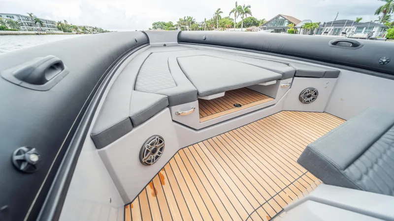 Slide: The Image of 2025 Skipper 38 boat interior with cushioned seating and wooden deck. - 11