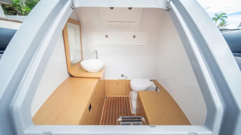 Slide: The Image of Modern Skipper 38 boat interior with wooden accents, featuring a compact bathroom, 2025 model. - 15