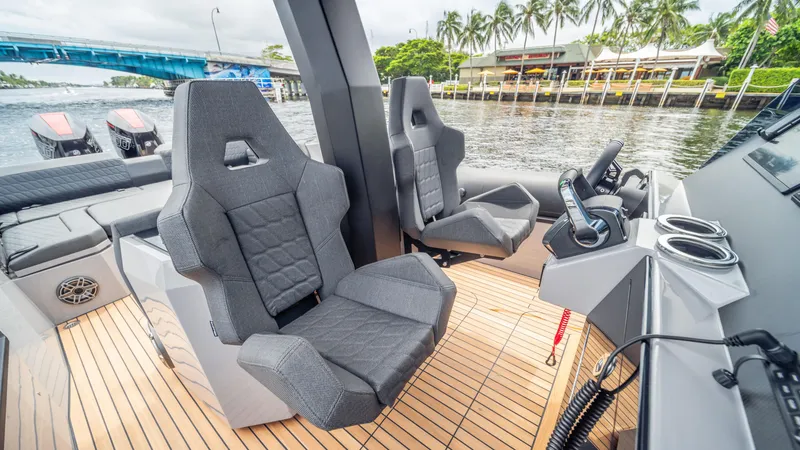 Slide: The Image of 2025 Skipper 38 boat interior with modern seats and control panel on a wooden deck. - 5