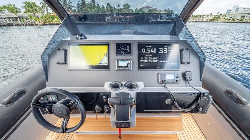 Slide: The Image of 2025 Skipper 38 boat dashboard with advanced navigation and control systems on a serene waterway. - 9
