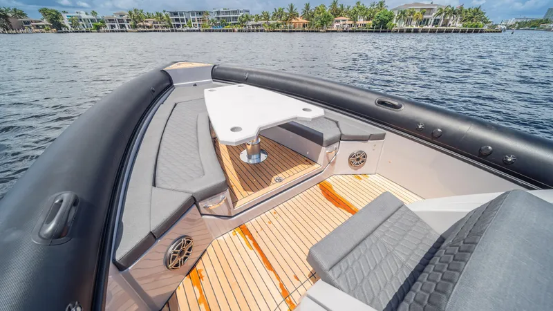 Slide: The Image of Luxury Skipper 38 boat interior with seating, table, and waterfront view, 2025 model. - 28