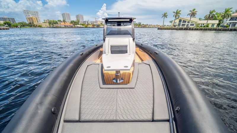 Slide: The Image of 2025 Skipper 38 boat on calm water, featuring sleek design and spacious deck. - 6