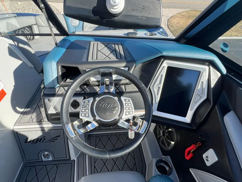 Slide: The Image of 2018 Tigé RZX3 boat dashboard with steering wheel and touchscreen display. - 18