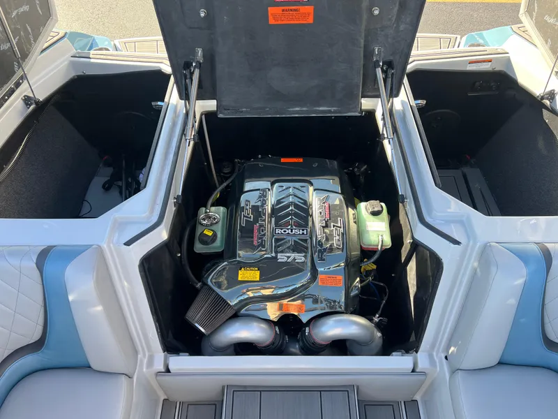 Slide: The Image of 2018 Tigé RZX3 boat engine compartment with Raptor 575 engine visible. - 23
