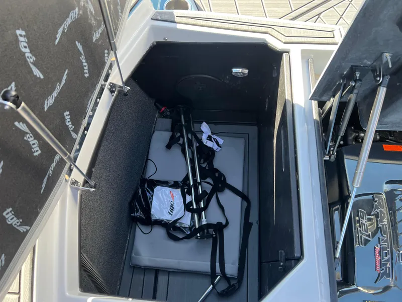 Slide: The Image of Open storage compartment in 2018 Tigé RZX3 boat with accessories inside. - 25