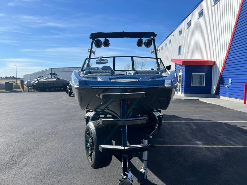 Slide: The Image of 2018 Tigé RZX3 boat on trailer in parking lot, sunny day, blue sky. - 7