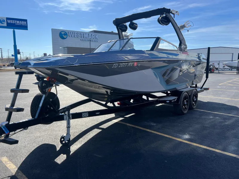 Slide: The Image of 2018 Tigé RZX3 boat on trailer in parking lot, Westmark Credit Union in background. - 8