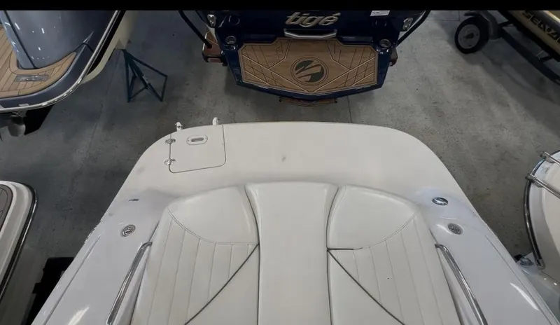 Slide: The Image of 2006 Four Winns 260 Horizon boat interior with white seating and deck details. - 13