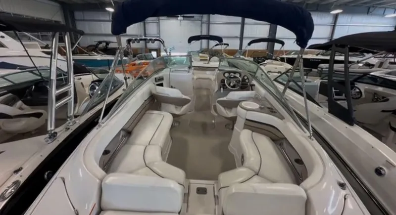 Slide: The Image of 2006 Four Winns 260 Horizon boat interior with white seating in a showroom. - 2