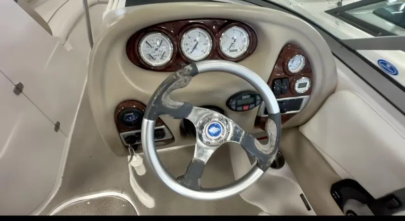 Slide: The Image of Steering wheel and dashboard of 2006 Four Winns 260 Horizon boat, featuring gauges and controls. - 3
