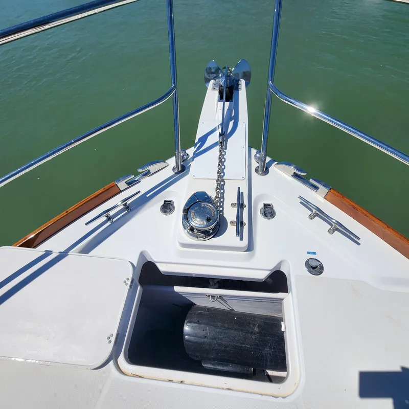 Slide: The Image of Bow of 2009 Sabre 34 Express yacht with anchor chain and railing. - 13