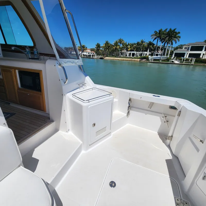 Slide: The Image of 2009 Sabre 34 Express boat interior with waterfront view and palm trees. - 16