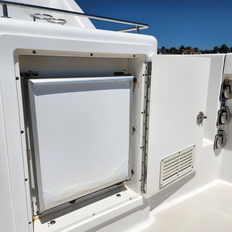 Slide: The Image of 2009 Sabre 34 Express boat with open storage compartment and visible latch details. - 17
