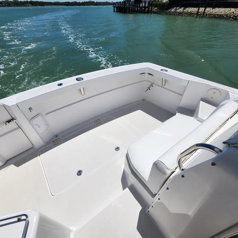 Slide: The Image of 2009 Sabre 34 Express boat deck with seating, cruising on calm waters. - 18