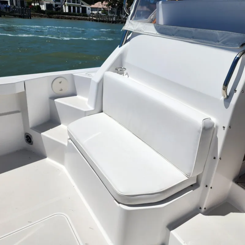 Slide: The Image of 2009 Sabre 34 Express boat with white seating and steps, docked near water. - 20