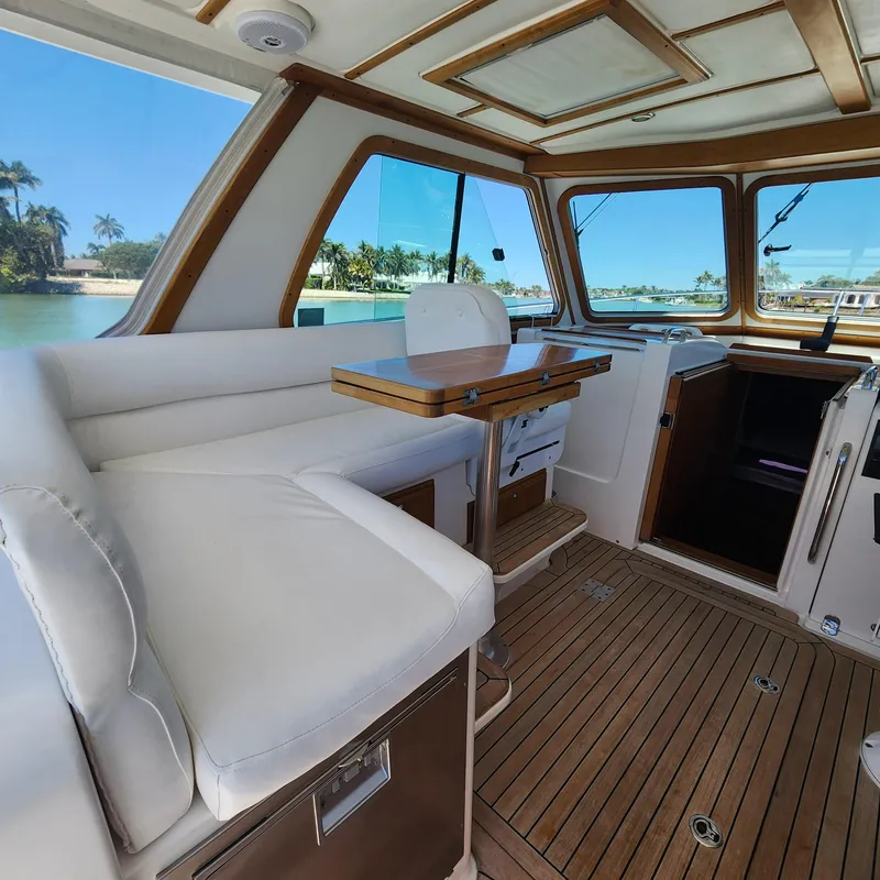 Slide: The Image of Interior of 2009 Sabre 34 Express yacht with wooden flooring and white seating. - 24