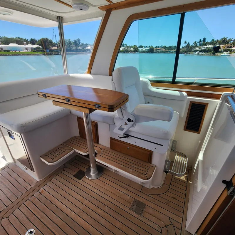 Slide: The Image of Interior of 2009 Sabre 34 Express yacht with wooden flooring and seating by a window. - 26