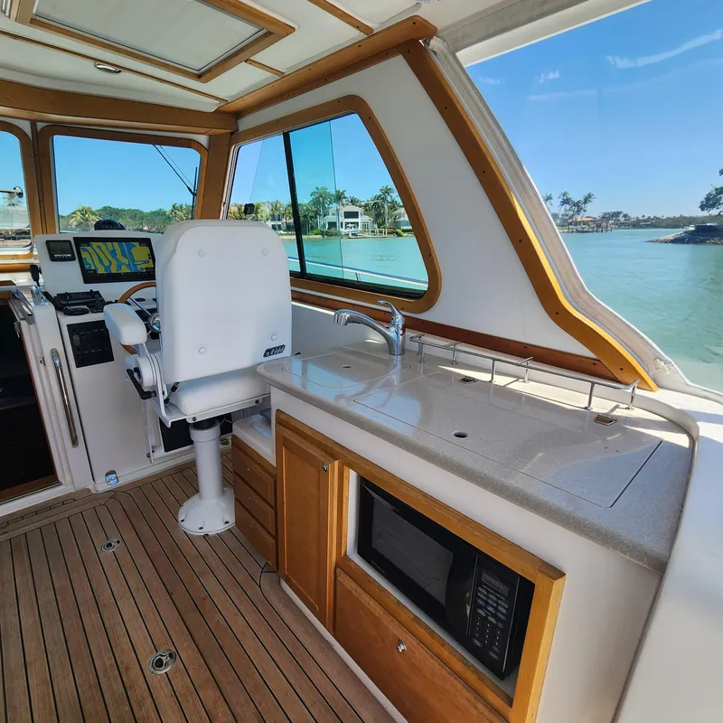 Slide: The Image of Interior of 2009 Sabre 34 Express boat with helm, sink, and microwave. - 29