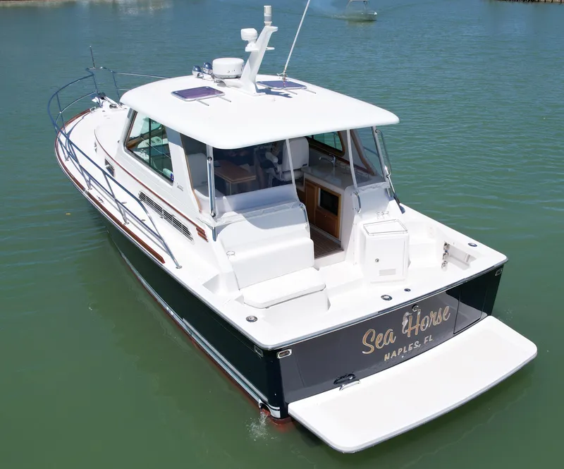 Slide: The Image of 2009 Sabre 34 Express boat on water, rear view, named "Sea Horse," Naples, FL. - 3