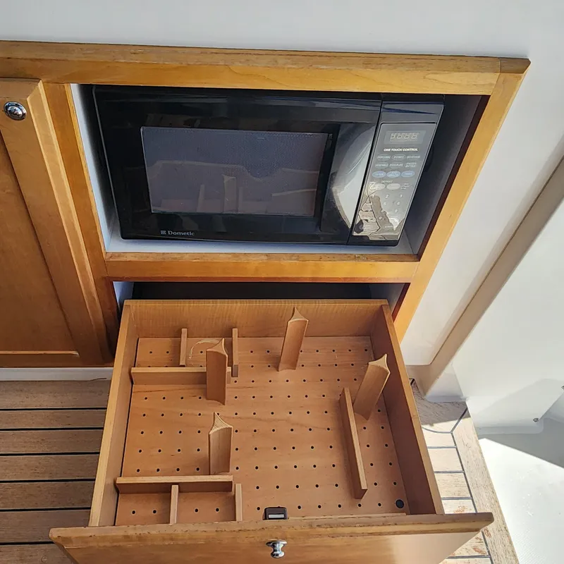 Slide: The Image of 2009 Sabre 34 Express interior with microwave and adjustable peg drawer system. - 34